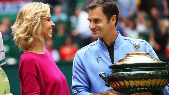 epa06049570 Roger Federer (R) of Switzerland holds his trophy as he talks with Czech model and actress Eva Herzigova (L) after defeating Alexander Zverev of Germany in their final match of the ATP ten ...
