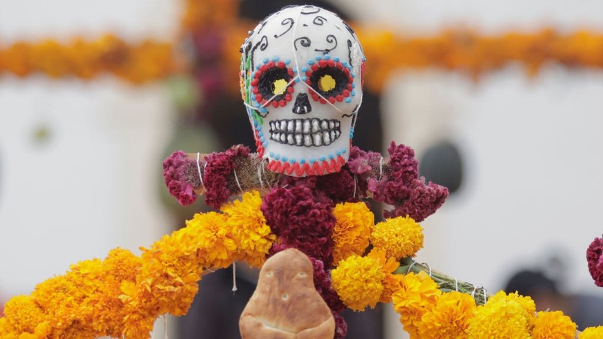 View inside the community pantheon of Janitzio Island located in the state of Michoacán, Mexico, where several people come to clean the tombs of their deceased loved ones, decorate them with cempasúch ...