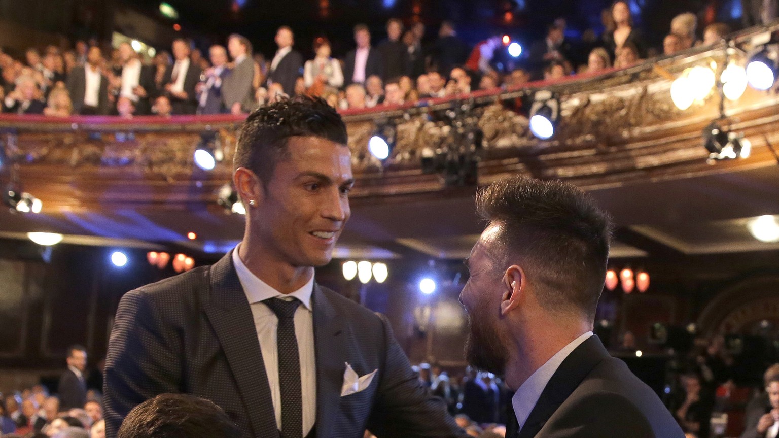 Portuguese soccer player Ronaldo, left, shakes hands wit Argentinian soccer player Lionel Messi during the The Best FIFA 2017 Awards at the Palladium Theatre in London, Monday, Oct. 23, 2017. (AP Phot ...