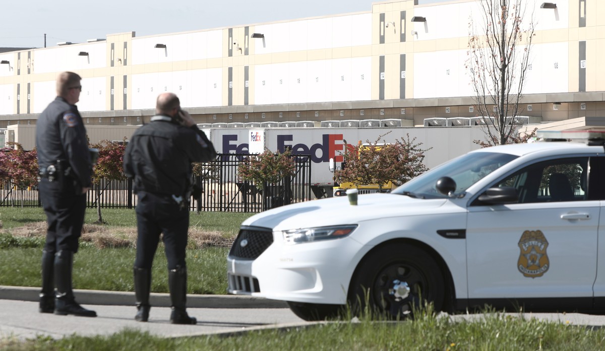 epa09139713 Indianapolis police guard the entrance to a FedEx facilty where a gunman had opened fire, in Indianpolis, Indiana, USA, 16 April 2021. According to police, a gunman has killed at least eig ...