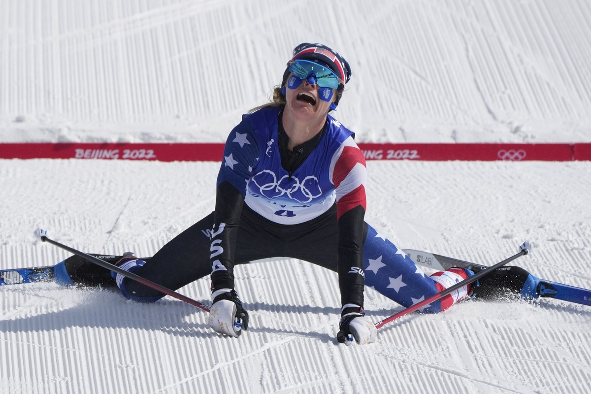 Jessie Diggins reacts after crossing the finish line during the women's 30km mass start free cross-country skiing competition at the 2022 Winter Olympics, Sunday, Feb. 20, 2022, in Zhangjiakou, C ...