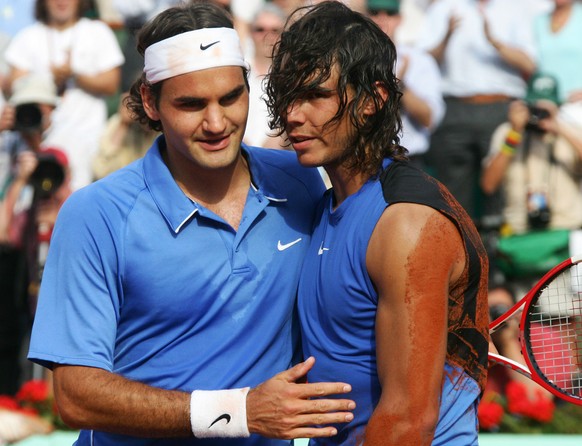 Spain&#039;s Rafael Nadal, right, gets a hug from Switzerland&#039;s Roger Federer after the men&#039;s final match during the French Open tennis tournament at the Roland Garros stadium in Paris, Sund ...