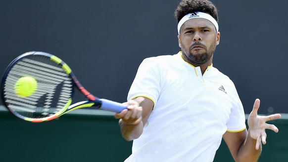 epa06067480 Jo-Wilfried Tsonga of France in action against Simone Bolelli of Italy during their second round match for the Wimbledon Championships at the All England Lawn Tennis Club, in London, Brita ...