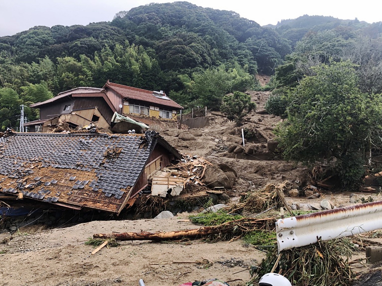 epa10736954 A handout photo made available by Karatsu City shows houses damaged by a landslide triggered by a heavy rain in Karatsu, Saga Prefecture, southwestern Japan, 10 July 2023. The Japan Meteor ...
