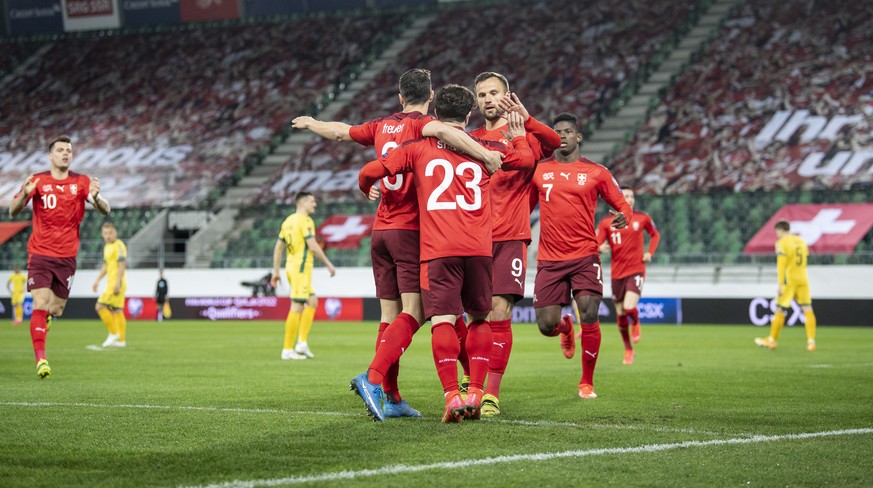 Swiss players Remo Freuler, left, and from right, Breel Embolo and Haris Seferovic, celebrate after Xherdan Shaqiri, center no 23, scored to 1:0 during the FIFA World Cup Qatar 2022 qualifying Group C ...