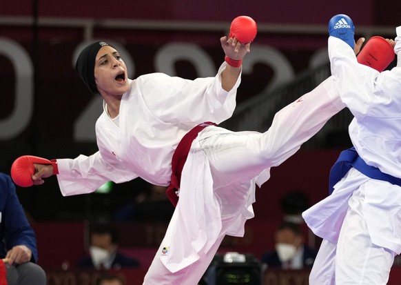 Feryal Abdelaziz of Egypt, left, and Hamideh Abbasali of Iran compete in the women&#039;s kumite +61kg elimination round for karate at the 2020 Summer Olympics, Saturday, Aug. 7, 2021, in Tokyo, Japan ...