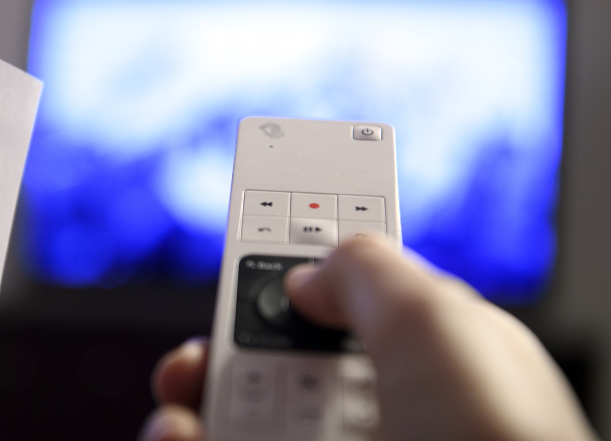 ARCHIVBILD ZUR MK DES BAKOM UEBER DIE NEUE FORMEL DER EMPFANGSGEBUEHREN, AM DIENSTAG, 23. OKTOBER 2018 - Une personne controle sa television a l'aide d'une telecomande Swisscom TV pour regar ...