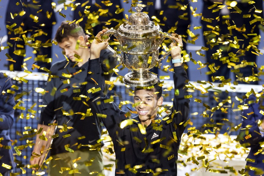 Winner Felix Auger-Aliassime of Canada poses with the trophy after defeating Holger Rune of Denmark during the award ceremony after their final match at the Swiss Indoors tennis tournament at the St.  ...