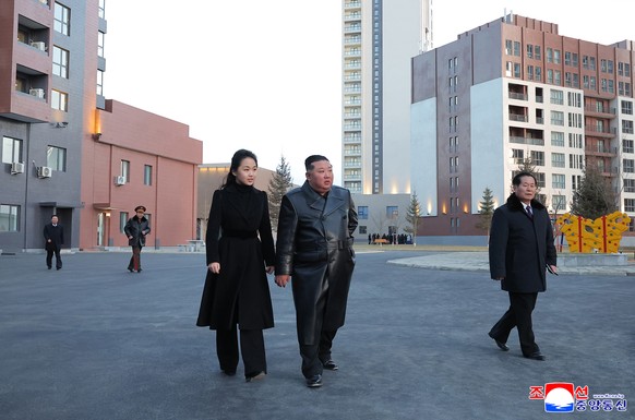 epa12745277 A photo released by the official Korean Central News Agency (KCNA) shows North Korean leader Kim Jong Un (center-R) and his daughter, Kim Ju Ae (center L), touring Saeppyol Street, a new h ...