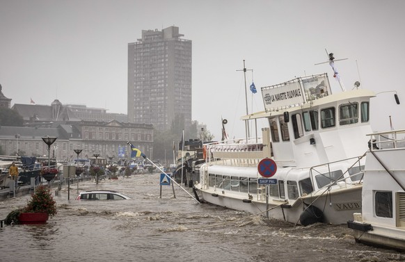 A car floats in the Meuse River during heavy flooding in Liege, Belgium, Thursday, July 15, 2021. Heavy rainfall is causing flooding in several provinces in Belgium with rain expected to last until Fr ...