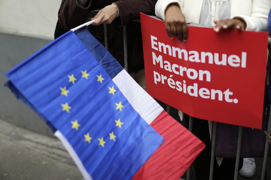 Supporters of French independent centrist presidential candidate Emmanuel Macron gather outside his campaign headquarters in Paris, France, Sunday, May 7, 2017. (AP Photo/Emilio Morenatti)