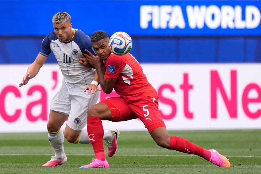 Bosnia's Ermedin Demirovic, left, and Switzerland's Manuel Akanji compete for the ball during the World Cup Group B soccer match between Switzerland and Bosnia in Inglewood, Calif., near Los ...