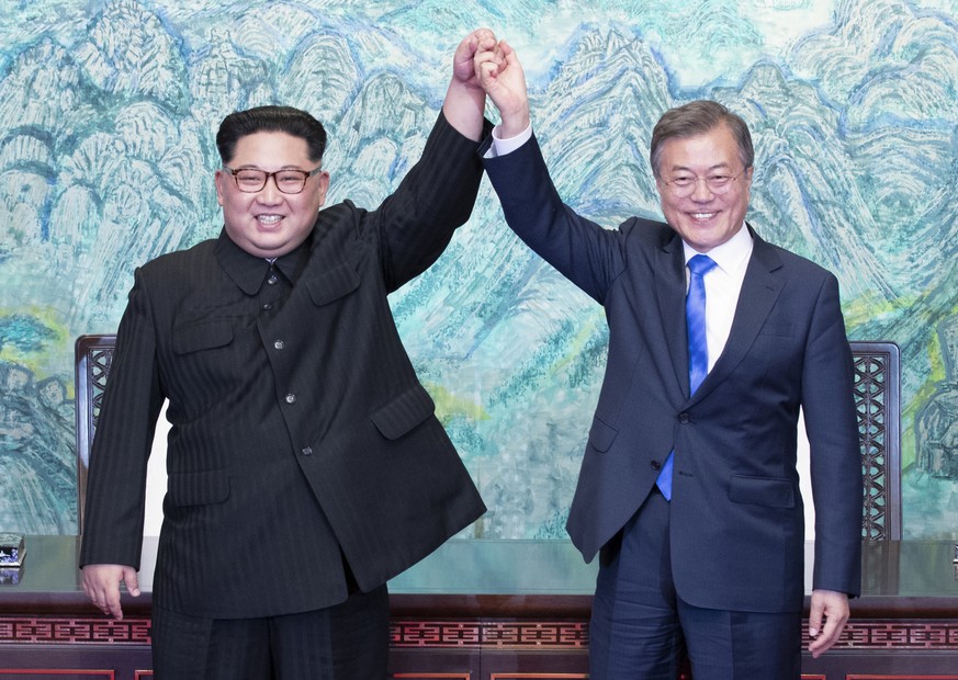 FILE- in this April 27, 2018, file photo, North Korean leader Kim Jong Un, left, and South Korean President Moon Jae-in raise their hands after signing on a joint statement at the border village of Pa ...