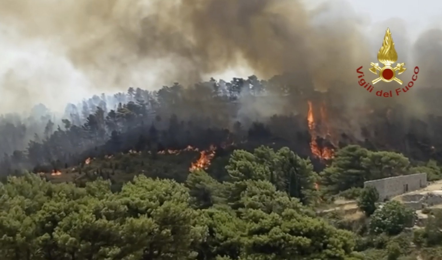 In this photo released by the Italian Firefighters, a view of a fire near Giarratana, in the province of Ragusa, Sicily, Italy, Thursday, Aug. 12, 2021, as many wildfires continue plaguing the region. ...