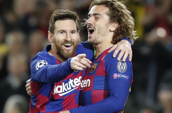 Barcelona's Lionel Messi, left, celebrates after scoring his side's second goal with Antoine Griezmann during a Champions League soccer match Group F between Barcelona and Dortmund at the Ca ...