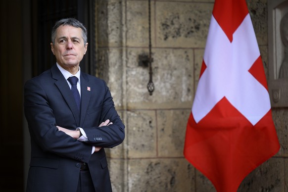 Swiss President and Foreign Minister Ignazio Cassis waits Belgium&#039;s Prime Minister Alexander De Crooa next to the Swiss flag before a bilateral meeting in the margin of the 10 years commemoration ...