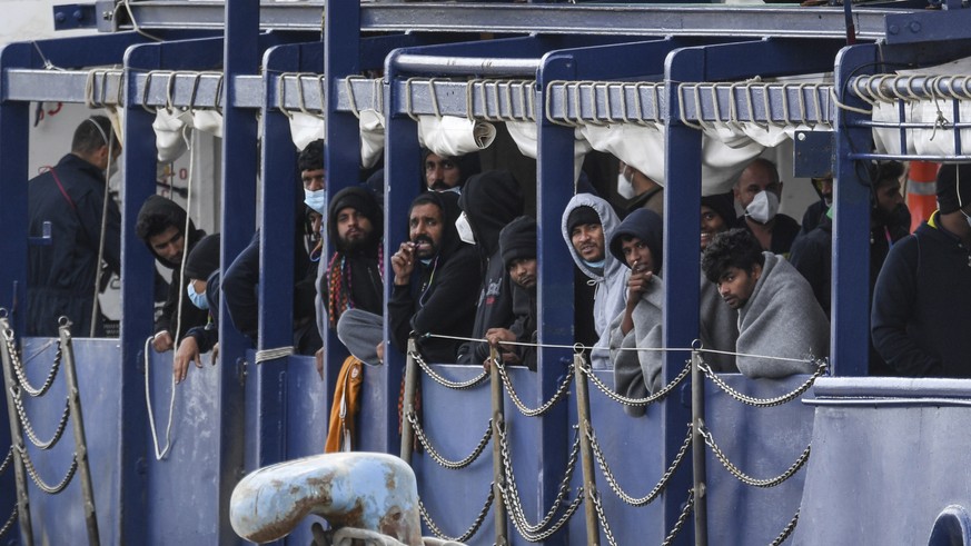 Migrants stand on the deck of the Humanity 1 rescue ship run by the German organization SOS Humanitarian, at harbor in the port of Catania, Sicily, southern Italy, Sunday, Nov. 6, 2022. The captain of ...