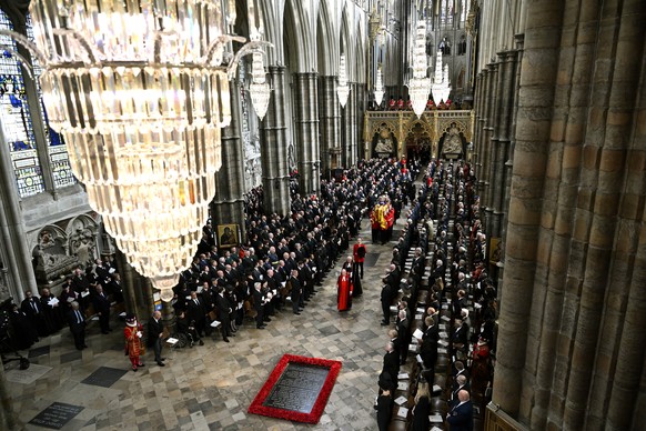 King Charles III, Camilla, the Queen Consort and other members of the Royal family follow behind the coffin of Queen Elizabeth II, draped in the Royal Standard with the Imperial State Crown and the So ...
