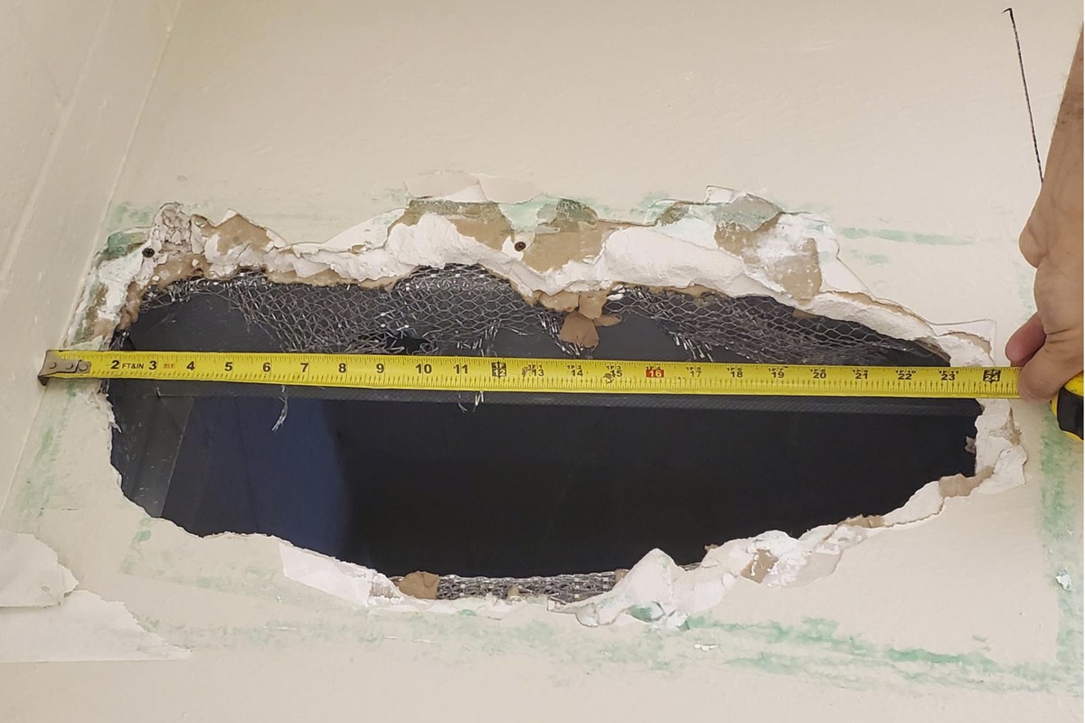 This photo provided Monday, Nov. 4, 2019, by the Monterey County Sheriff's Office shows a hole that Santos Fonseca and Jonathan Salazar escaped through in the county jail in Salinas, Calif. Two m ...