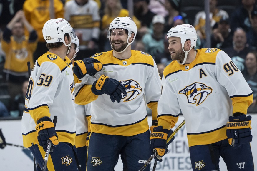 Nashville Predators forward Filip Forsberg, center, defensman Roman Josi, left, and forward Ryan O&#039;Reilly celebrate an empty-net goal against the Seattle Kraken during the third period of an NHL  ...