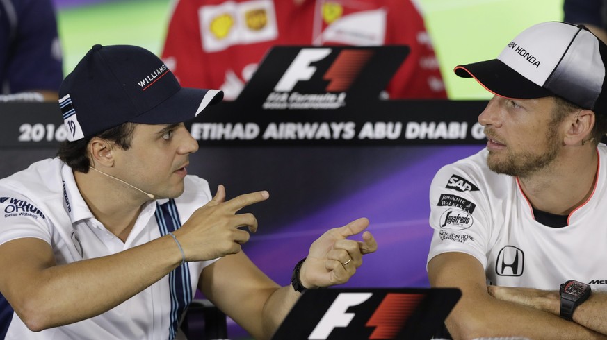 epa05645246 Brazilian Formula One driver Felipe Massa of Williams (L) talks to British Formula One driver Jenson Button of McLaren-Honda (R) during the press conference at Yas Marina Circuit in Abu Dh ...