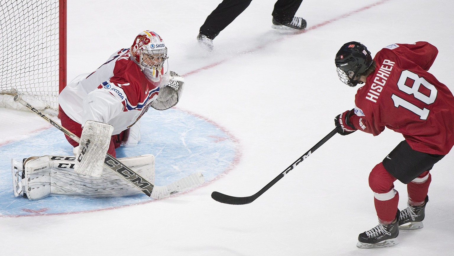 Switzerland&#039;s Nico Hischier (18) scores on Czech Republic&#039;s goaltender Jakub Skarek during the overtime period inpreliminary round IIHF World Junior Championship hockey action in Montreal, T ...