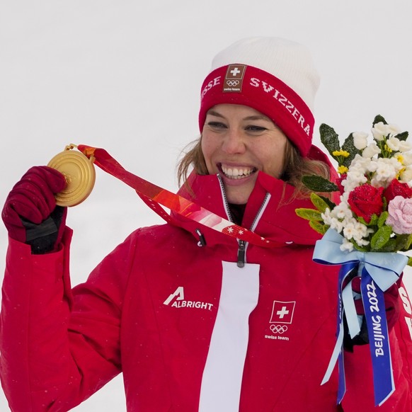 Michelle Gisin, of Switzerland, celebrates winning the gold medal in the women's combined at the 2022 Winter Olympics, Thursday, Feb. 17, 2022, in the Yanqing district of Beijing. (AP Photo/Mark  ...