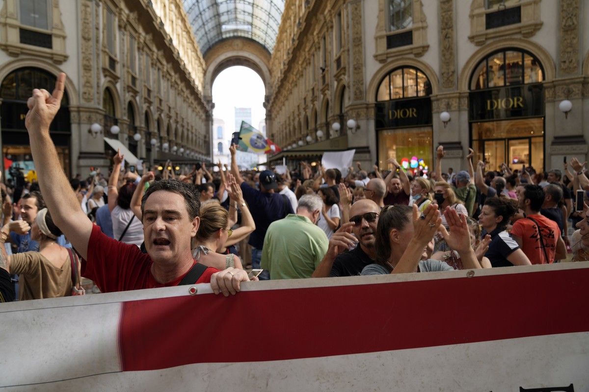 People stage a protest against the "green pass" in Milan, Italy, Saturday, July 24, 2021. Italy's government approved a decree ordering the use of the so-called "green" passes ...