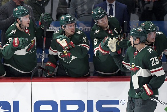 Minnesota Wild&#039;s Charlie Coyle (3), Zach Parise (11), Mikko Koivu (9), of Finland, and Mikael Granlund (64), also of Finland, congratulate defenseman Jonas Brodin (25), of Sweden, for scoring a s ...