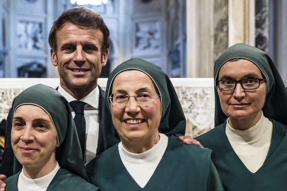 epa10263244 French President Emmanuel Macron during his visit to the Basilica of St John Lateran in Rome, Italy, 24 October 2022. Macron is on an official visit to Italy, the French president has met  ...
