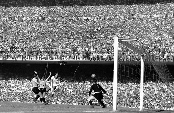 Brazil&#039;s Francisco Aramburu, in white, heads the ball past Uruguay&#039;s goalkeeper Roque Maspoli, right, watched by Uruguay&#039;s Eusebio Tejera, first left, and Schubert Gambeta, second left, ...