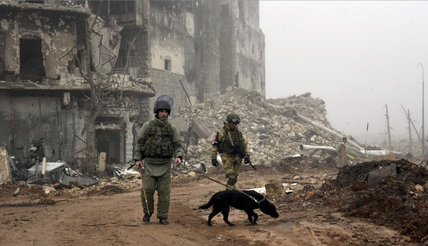 FILE This file photo made from the footage taken from Russian Defense Ministry official website on Saturday, Feb. 4, 2017, claims to show Russian sappers looking for mines in a street in Aleppo, Syria ...