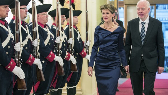 Simonetta Sommaruga, Swiss Federal President, left, and her husband Lukas Hartmann, right, arrive at the Bernerhof for the Gala Dinner for Francois Hollande, President of France, in Bern, Switzerland, ...