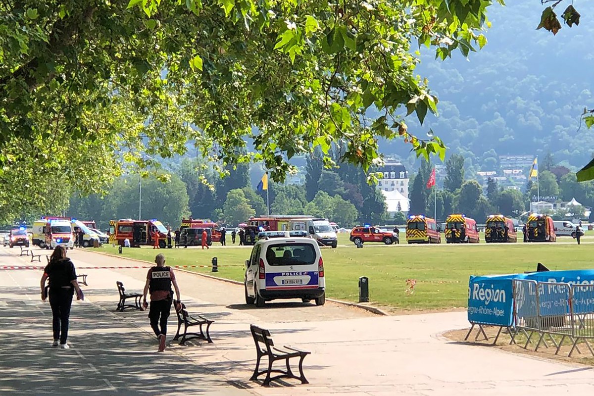 Police officers and rescuers walk at the scene after a knife attack in a park of Annecy, French Alps, Thursday, June 8, 2023. An attacker with a knife stabbed several young children and at least one a ...
