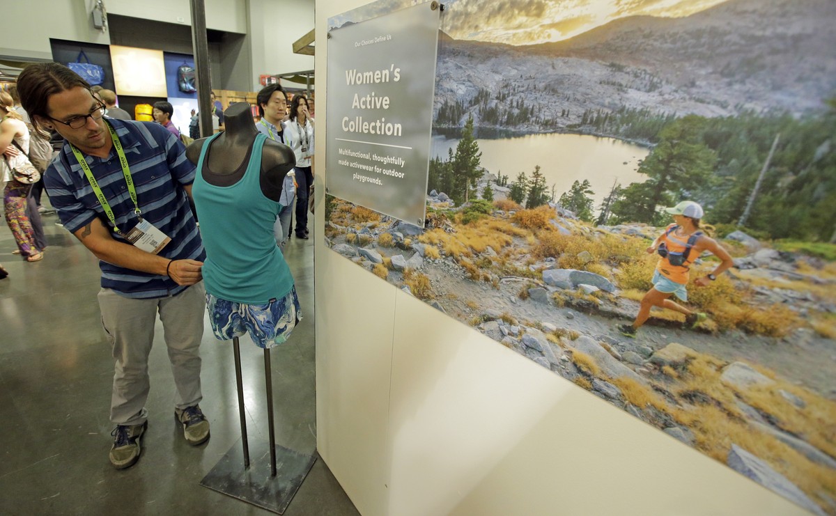 Exhibitor Trevor Masters, of Patagonia, Inc., poses with a mannequin in the women's active collection at their exhibit during the Outdoor Retailer show Thursday, Aug. 4, 2016, in Salt Lake City.  ...