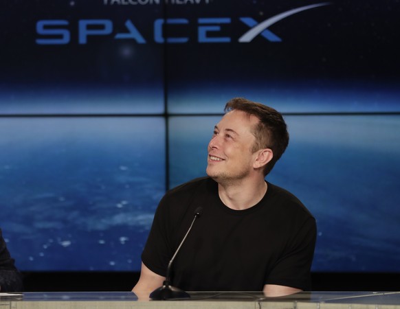 Elon Musk, founder, CEO, and lead designer of SpaceX, speaks at a news conference after the Falcon 9 SpaceX heavy rocket launched successfully from the Kennedy Space Center in Cape Canaveral, Fla., Tu ...