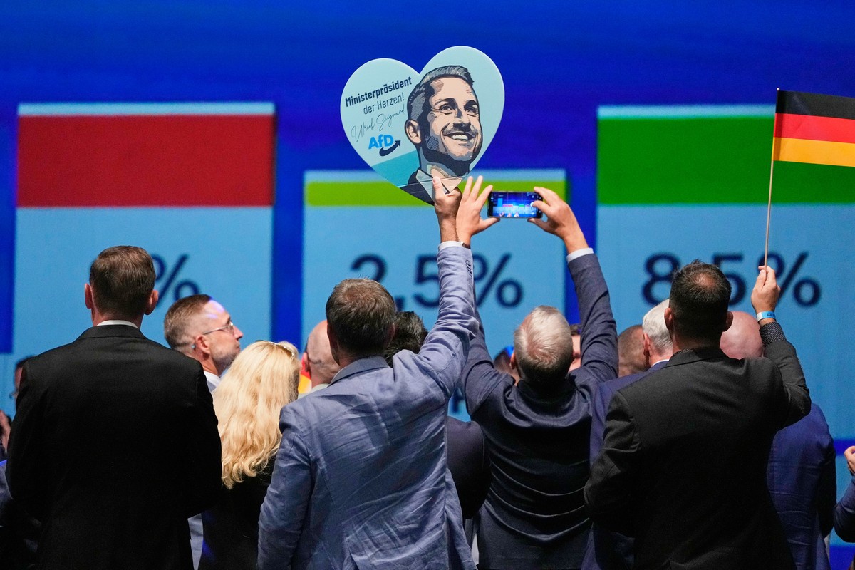 Party members celebrate with a sign of AfD top candidate Ulrich Siegmund after the first results at an election party of the "Alternative for Germany" (AfD) after the Saxony-Anhalt state ele ...