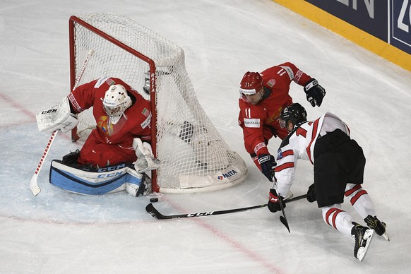 epa05950991 Goalkeeper Mikhail Karnaukhov (L) and forward Alexander Kulakov (C) in action against Mike Matheson (R) of Canada during the 2017 IIHF Ice Hockey World Championship group B preliminary rou ...