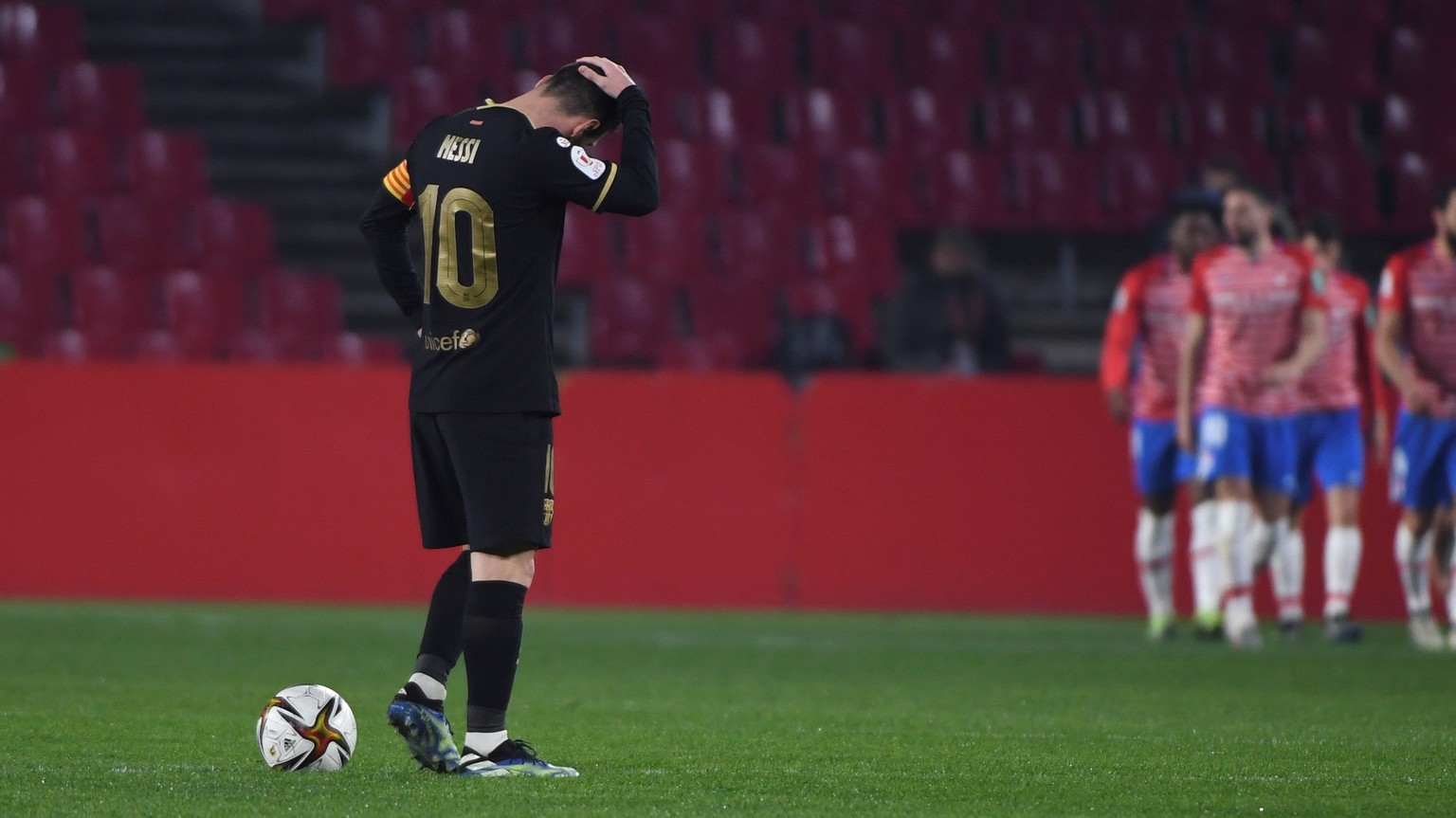 epa08985724 Barcelona&#039;s striker Leo Messi reacts after Granada&#039;s second goal during the Spanish King&#039;s Cup quarter finals soccer match between Granada FC and FC Barcelona at Nuevo Los C ...