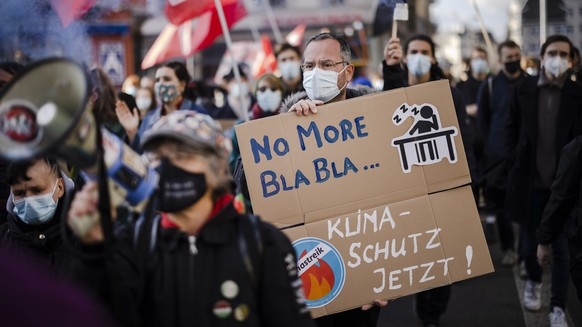 epa09567669 People attend a Climate Strike demonstration in Zuerich, Switzerland, 06 November 2021. People took part in the demonstration demanding world leaders to take action against climate change  ...