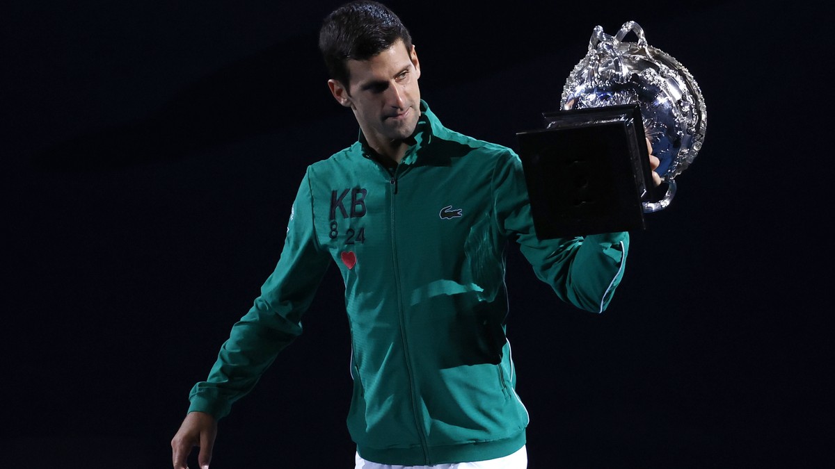 Serbia's Novak Djokovic carries the Norman Brookes Challenge Cup around Rod Laver Arena after defeating Austria's Dominic Thiem in the men's singles final of the Australian Open tennis  ...