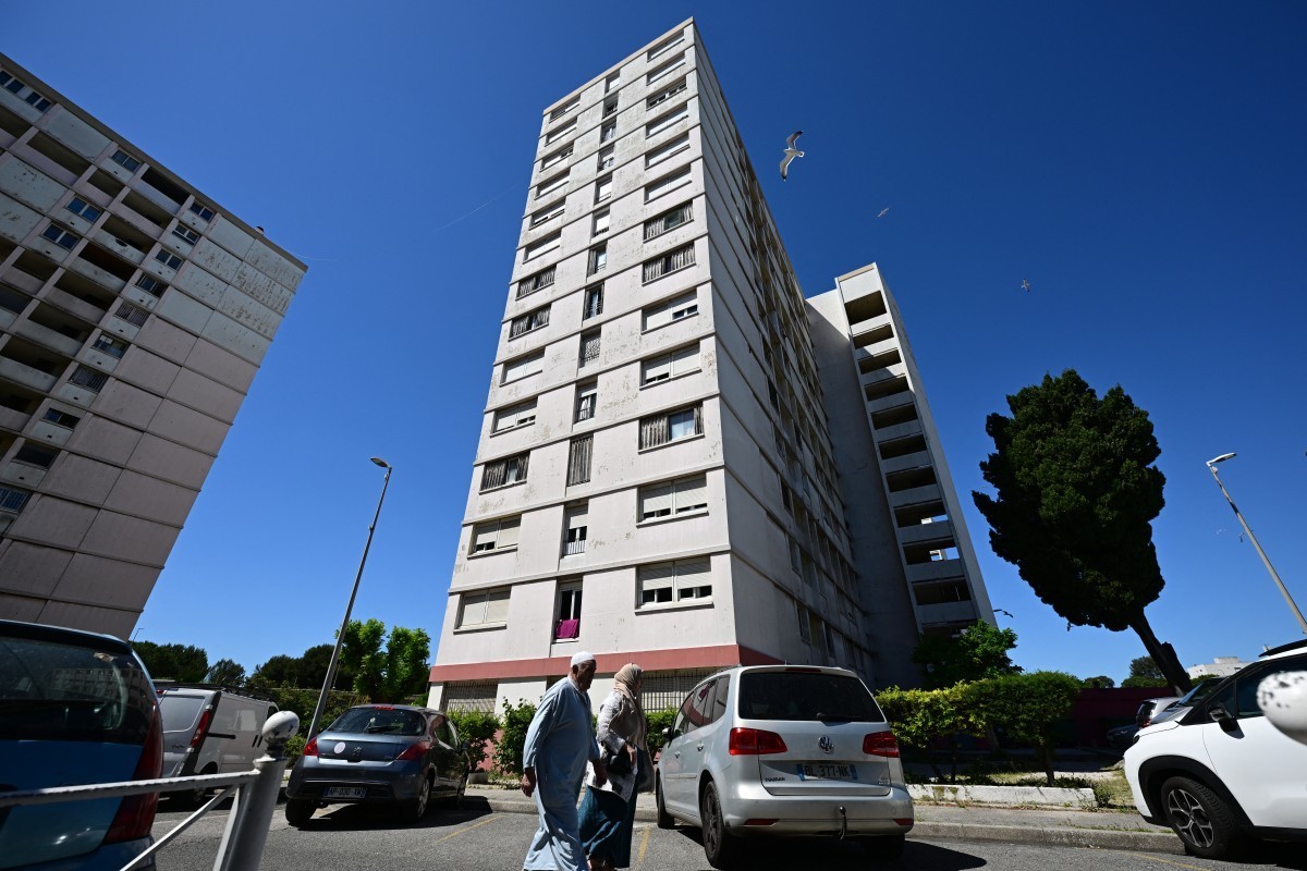This photo taken on May 20, 2026 shows a block of flats in the Pontcarral projects where a mother threw herself out of a 13th-floor window with three of her young children in Toulon, southern France.  ...