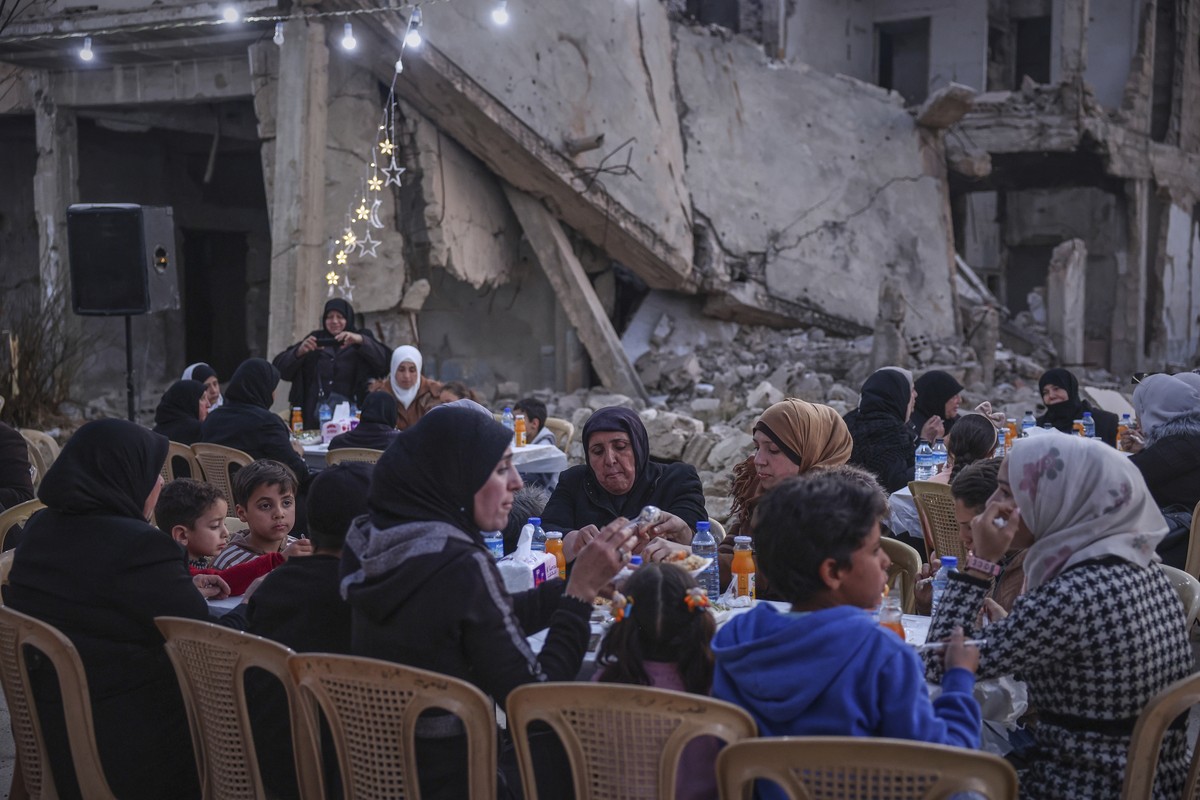 Widows and mothers of war victims gather for Iftar, the fast-breaking meal, organized by local NGOs in the devastated Jobar neighborhood of Damascus, Syria, Friday, March 14, 2025. (AP Photo/Ghaith Al ...