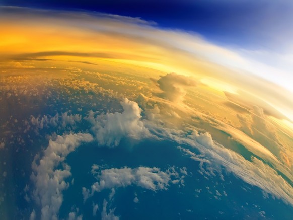 &quot;Aerial view of Planet Earth with clouds, horizon and little bit of space, make feelings of being in heaven. Dramatic clouds and orange sunlight all over the planet. Cloudscape and stratosphere f ...