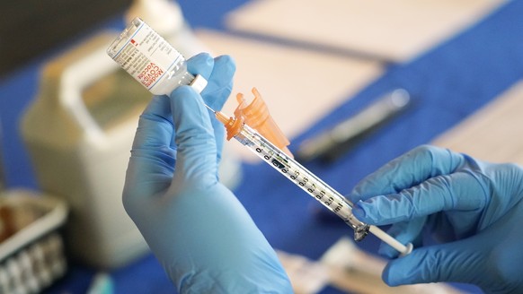 FILE - A nurse prepares a syringe of a COVID-19 vaccine at an inoculation station in Jackson, Miss., July 19, 2022. U.S. health officials are proposing a simplified approach to COVID-19 vaccinations,  ...