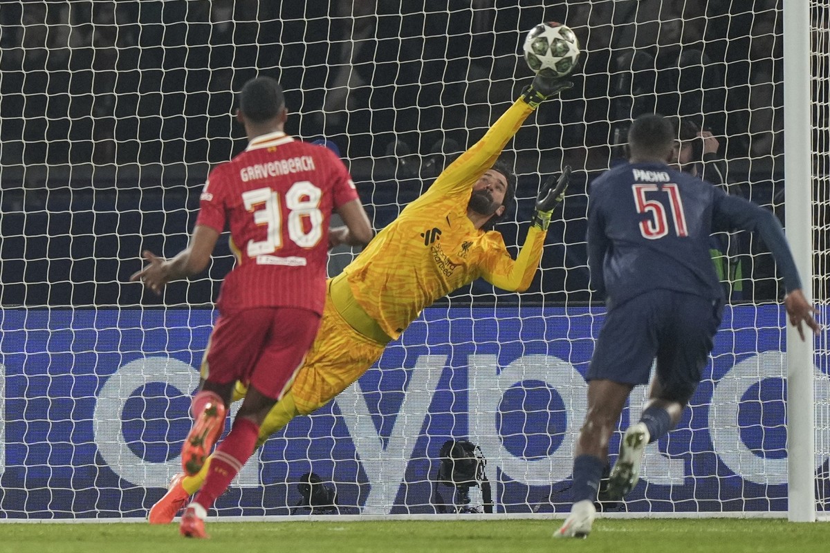 Liverpool's goalkeeper Alisson makes a save during the Champions League round of 16 first leg soccer match between Paris Saint-Germain and Liverpool at the Parc des Princes in Paris, Wednesday, M ...