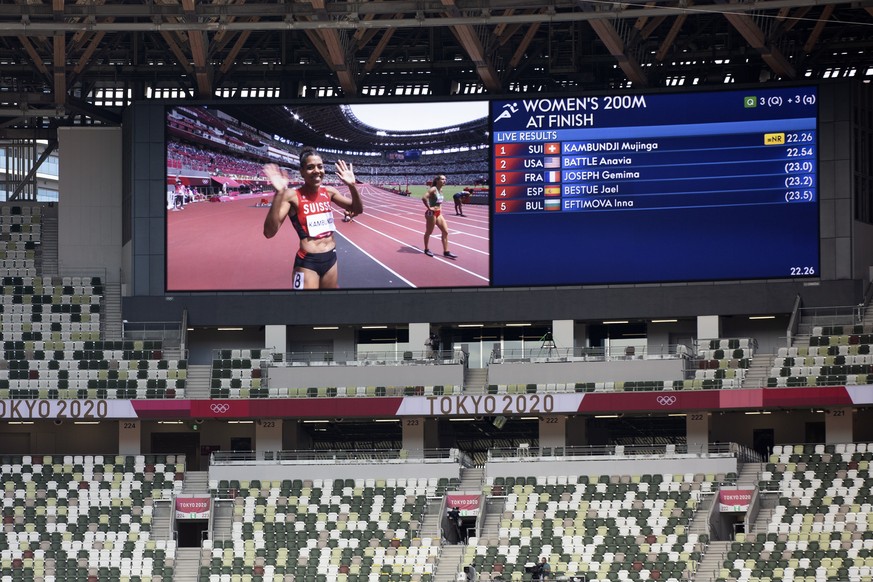 Mujinga Kambundji of Switzerland seen on a screen in the empty stadium after competing in the women&#039;s athletics 200m heats at the 2020 Tokyo Summer Olympics in Tokyo, Japan, on Monday, August 02, ...