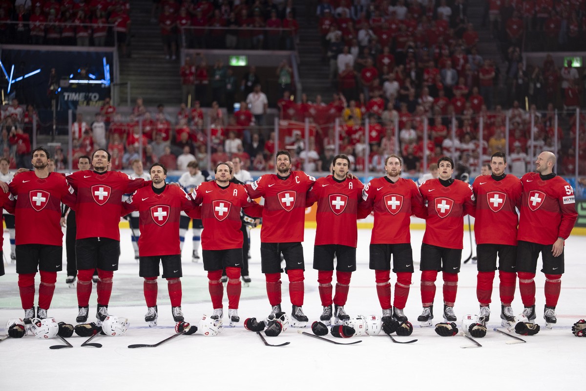 The Swiss team stands in line during the anthem played after the 2026 IIHF Men's Ice Hockey World Championship preliminary round group A game between Switzerland and Finland, at the Swiss Life Ar ...