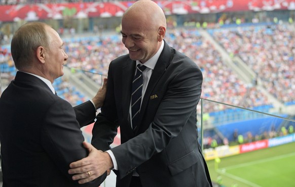 FILE- In this Saturday, June 17, 2017 file photo, Russian President Vladimir Putin, left, and FIFA President Gianni Infantino shake hands during the Confederations Cup, Group A soccer match between Ru ...