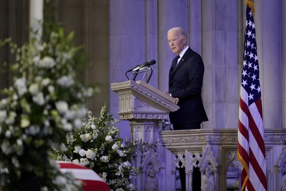 President Joe Biden speaks a tribute next to the flag-draped casket of former President Jimmy Carter, during a state funeral at Washington National Cathedral, Thursday, Jan. 9, 2025, in Washington. (A ...